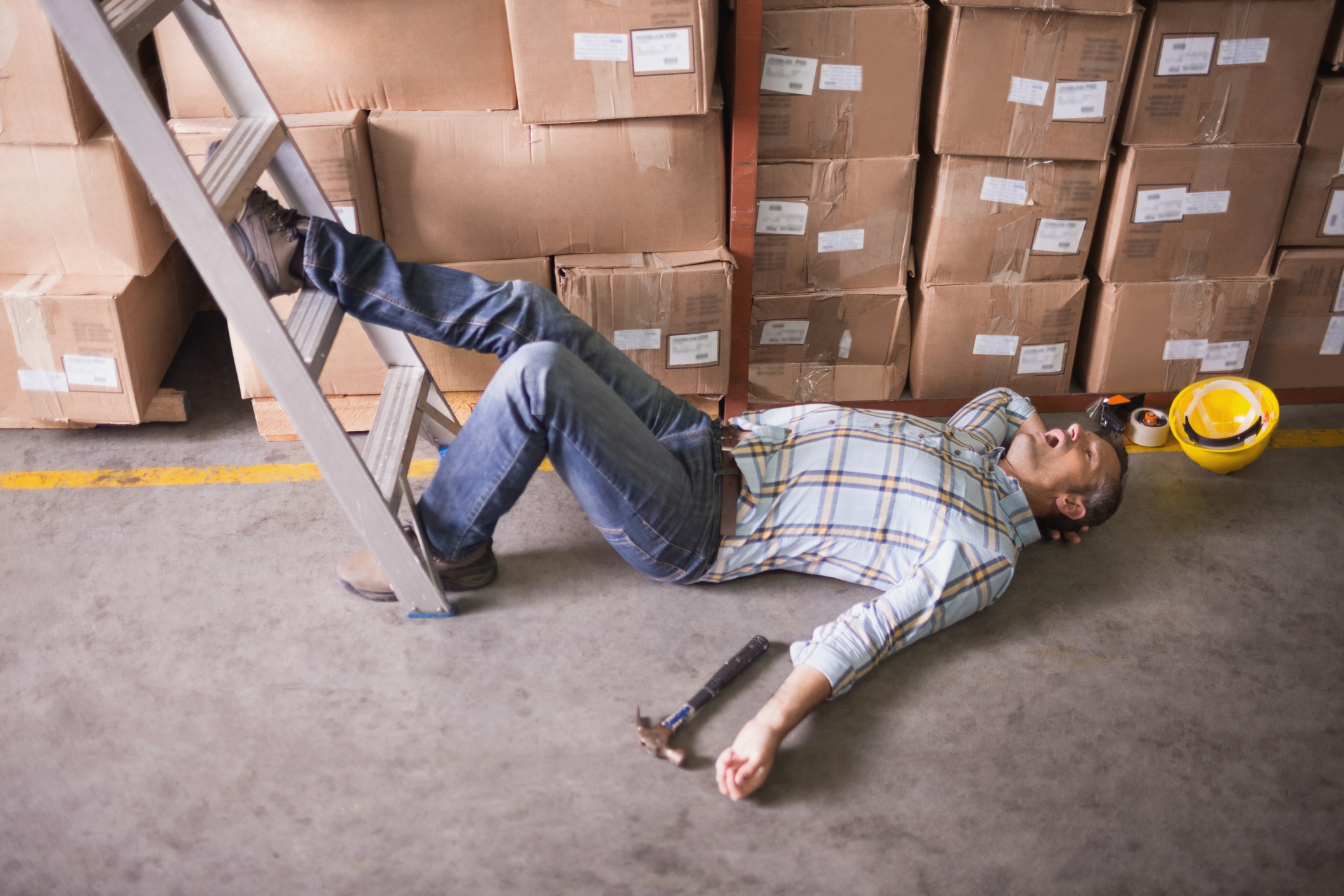 Worker lying on the floor in warehouse